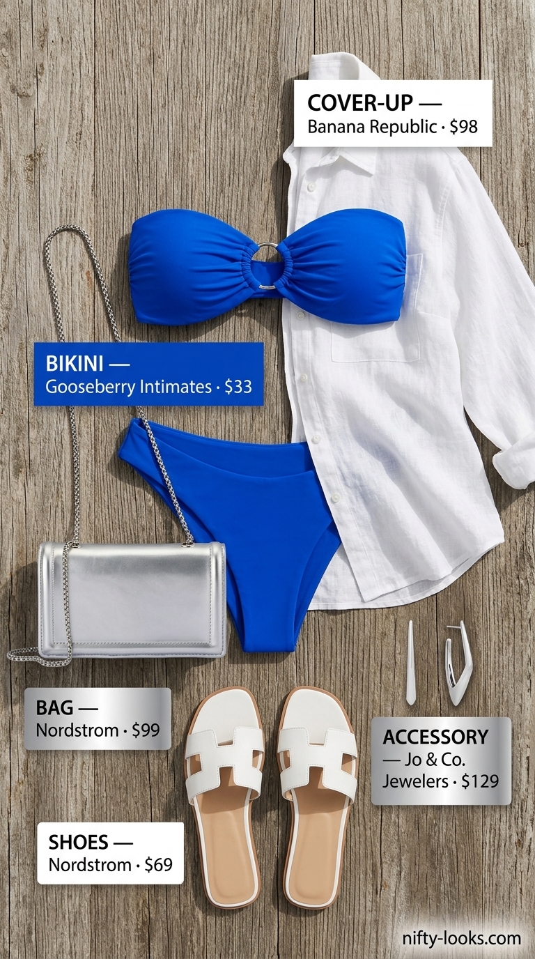Modern minimalist summer bikini outfit for women 2026 in cobalt blue, white, silver. Features bandeau bikini, linen shirt, white slides.