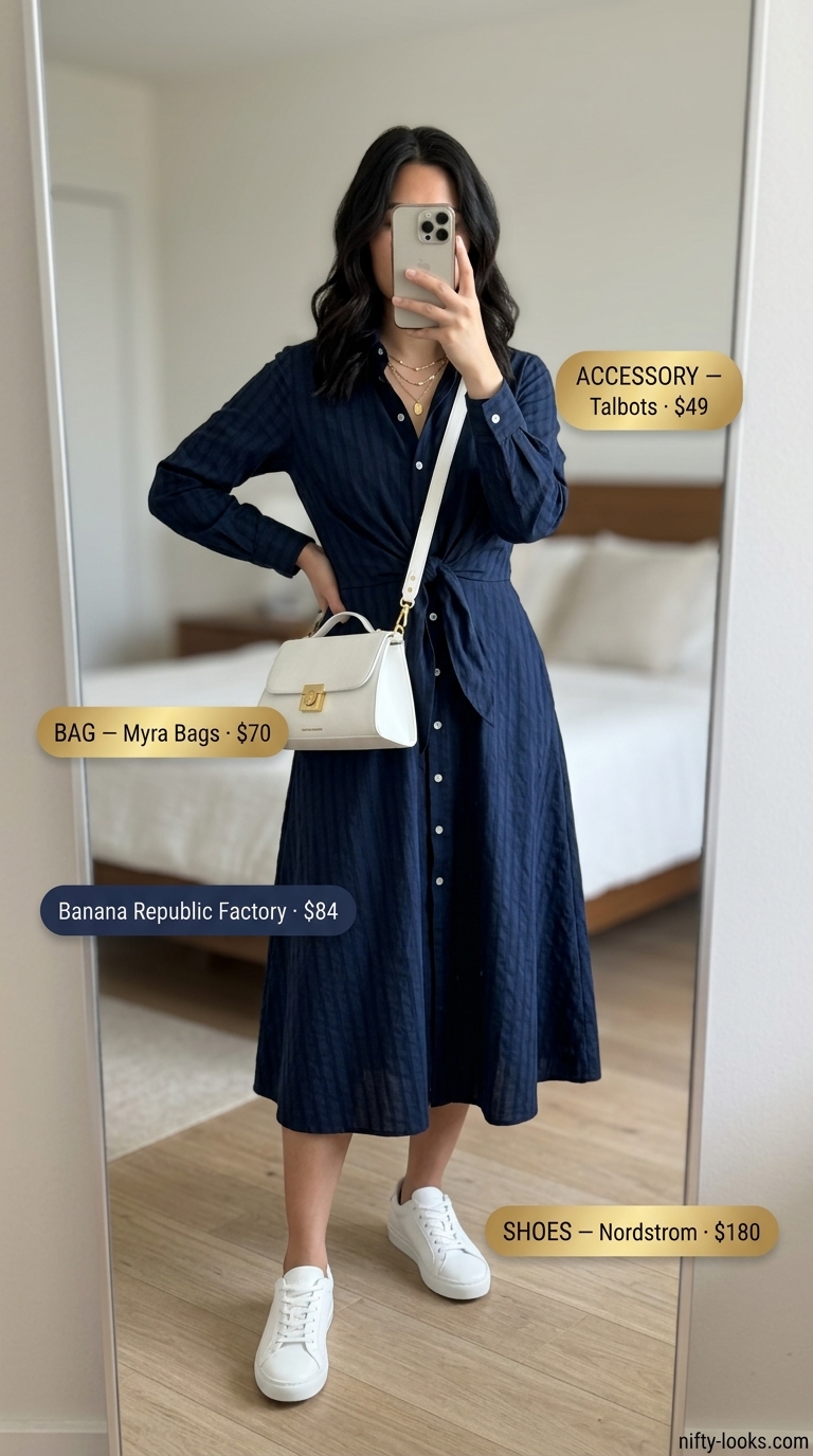 Sophisticated navy blue cotton poplin shirt dress for women 2026 city exploration with white sneakers.