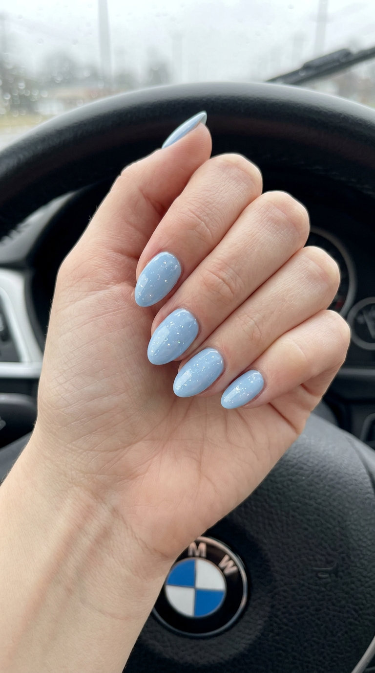 Baby blue almond nails with holographic flecks, a dreamy option for almond summer nails 2026 for fair skin.