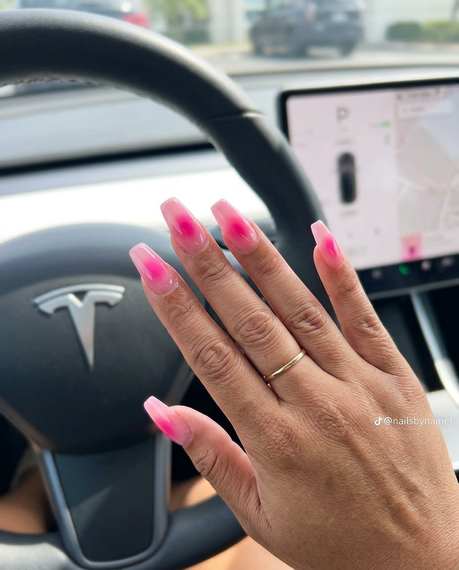 Fun summer nails 2026: Edgy hot pink aura gradient stiletto nails for parties and festivals.