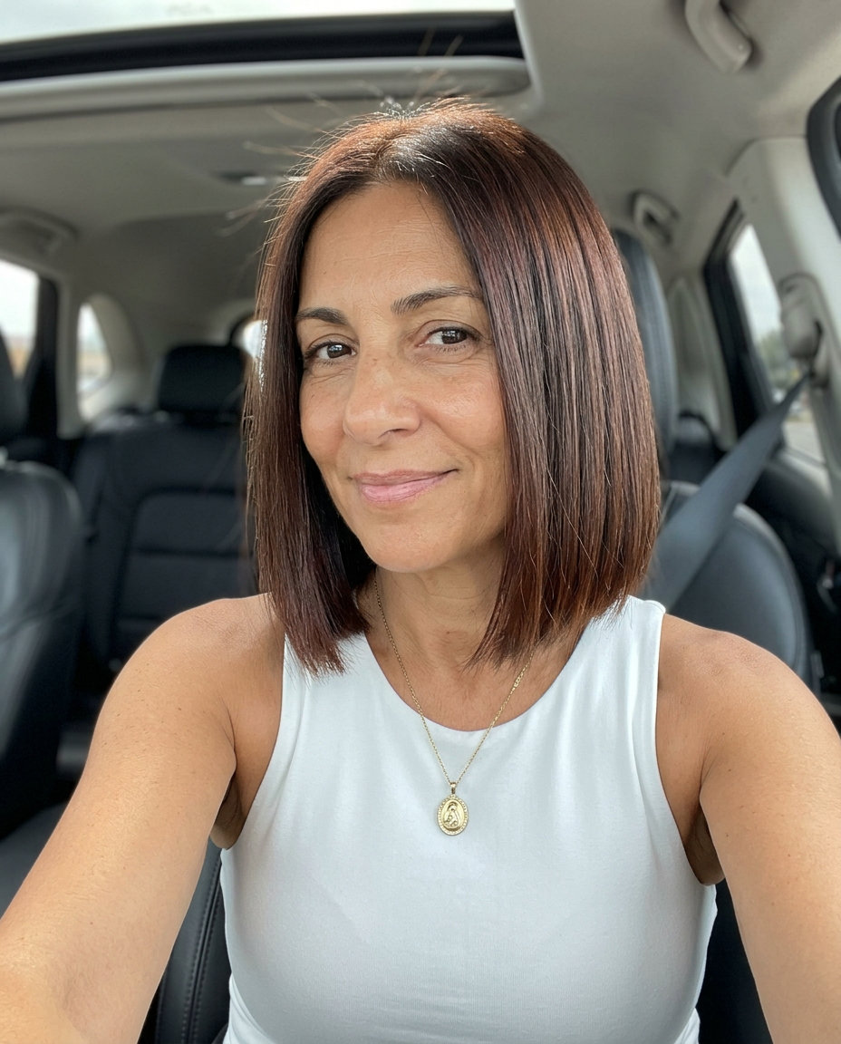 chin-length bob haircut in rich natural brunette with mahogany undertones, sharp blunt perimeter, no fringe — sophisticated and polished