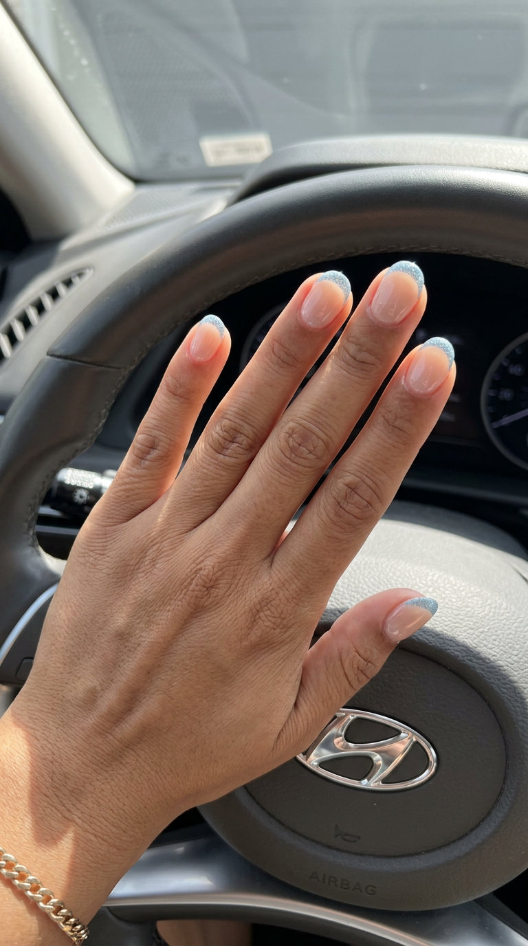 Light Blue Glitter French Nails 2026: Night Out Short round summer nails 2026: Light Blue Glitter French Tips for parties. Glamorous, sparkly, fun.