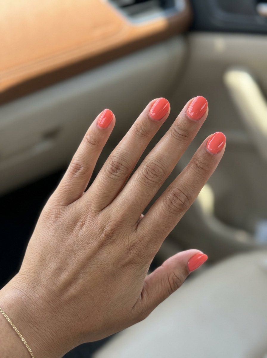 Tropical Coral Glossy Nails 2026: Vacation Vibes Short round summer nails 2026: Tropical Coral Glossy Solids for vacation. Playful, vibrant, energetic.