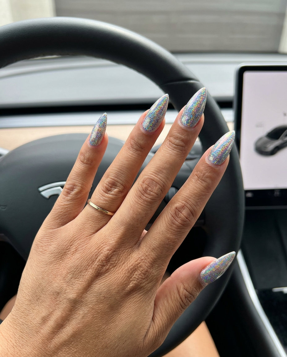 Holographic glitter stiletto accent nails for parties or vacation glam. Stiletto summer nails 2026.