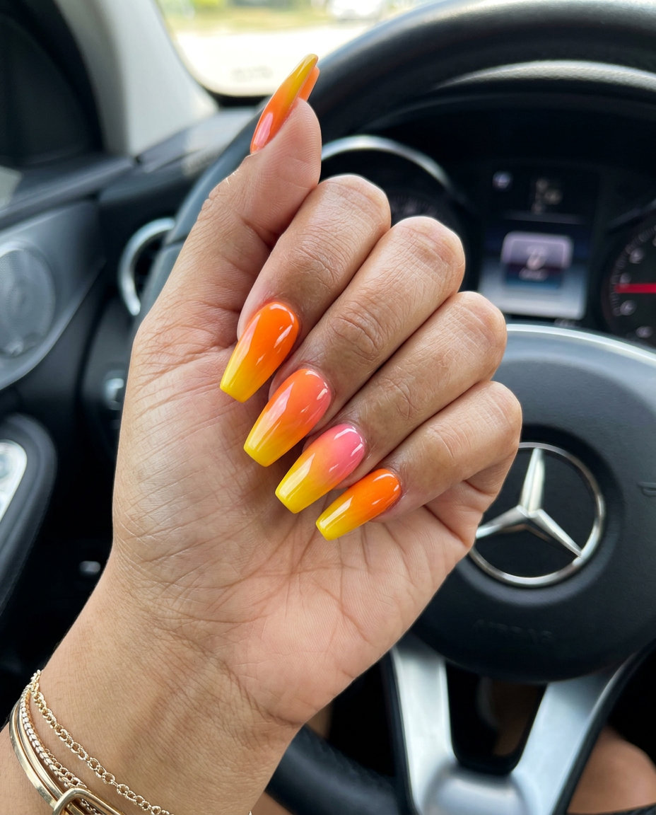Sunset Ombre Coffin Summer Nails 2026 Sunset Ombre Coffin nails for summer nails 2026: Vibrant orange to yellow gradient on long coffin nails for a playful, energetic look.