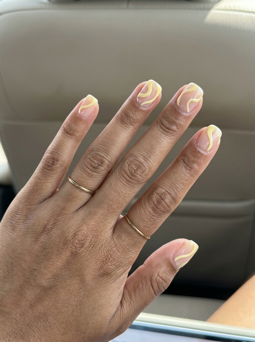 Minimalist butter yellow swirls on negative space for summer nails yellow 2026, ideal for daily wear.