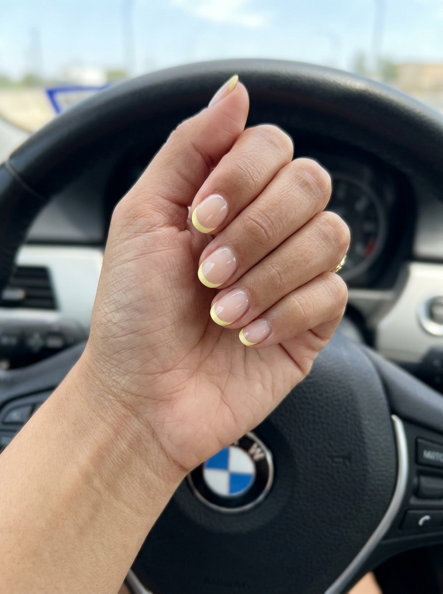 Minimalist pastel yellow micro French tip nails on a sheer nude base. Chic work-appropriate summer nails yellow 2026.
