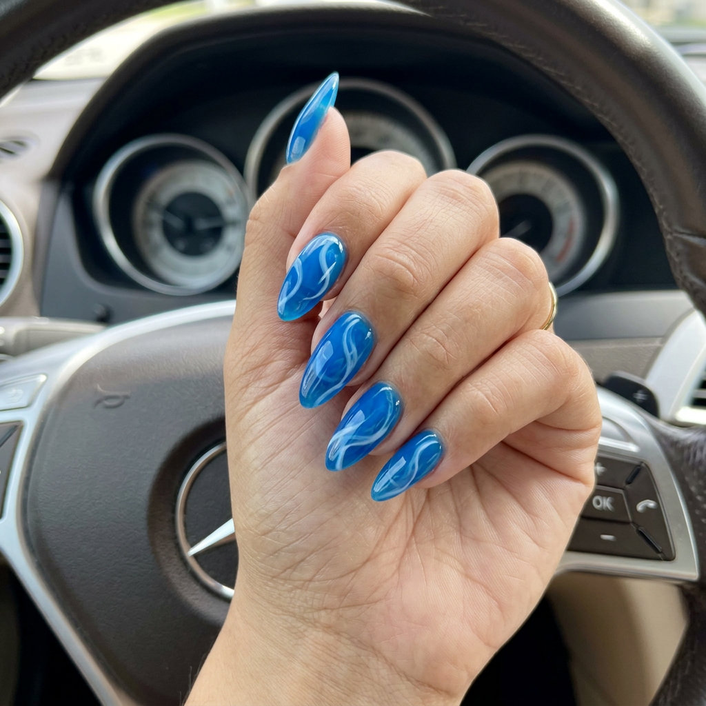 Electric Blue Jelly Water Ripple nails: electric blue jelly with white swirls for vacation, beach day, casual. Tropical nail designs 2026.