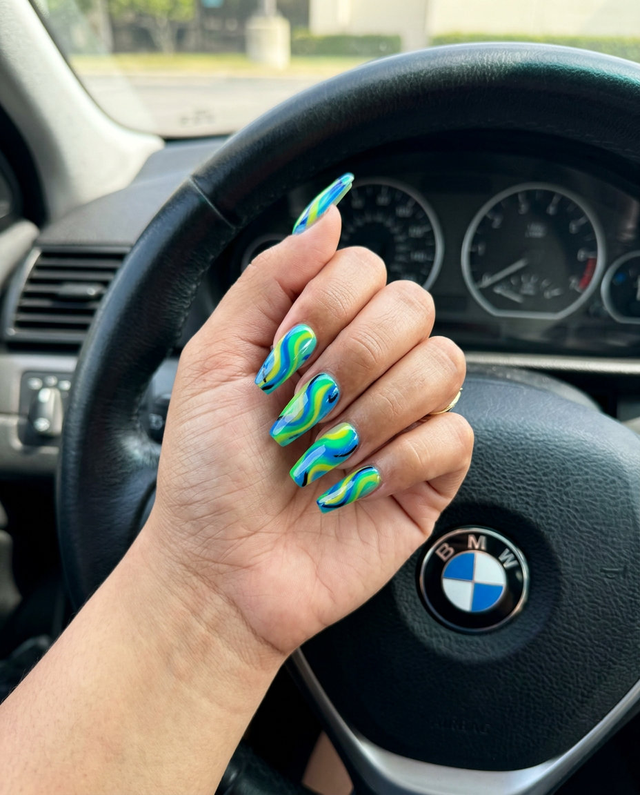 Vibrant parrot feather abstract swirls tropical nail designs 2026, electric blue, green, yellow gel polish, coffin nails.