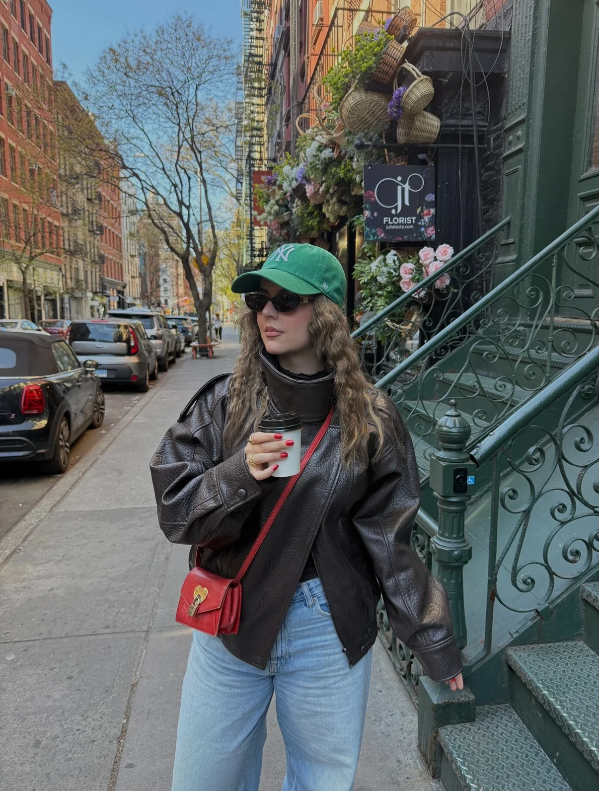 fall street style nyc outfits 2026 Oversized Leather Jacket And Green Cap For Cool Coffee Runs