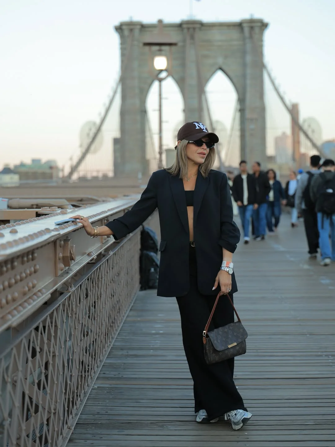 fall street style nyc outfits 2026 Relaxed Black Tailoring With Sporty Accessories At Sunset
