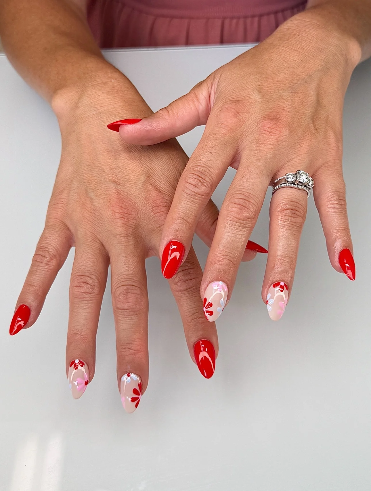 nail designs for august 2026 Bold Red Floral Almond Nails For A Confident August Look