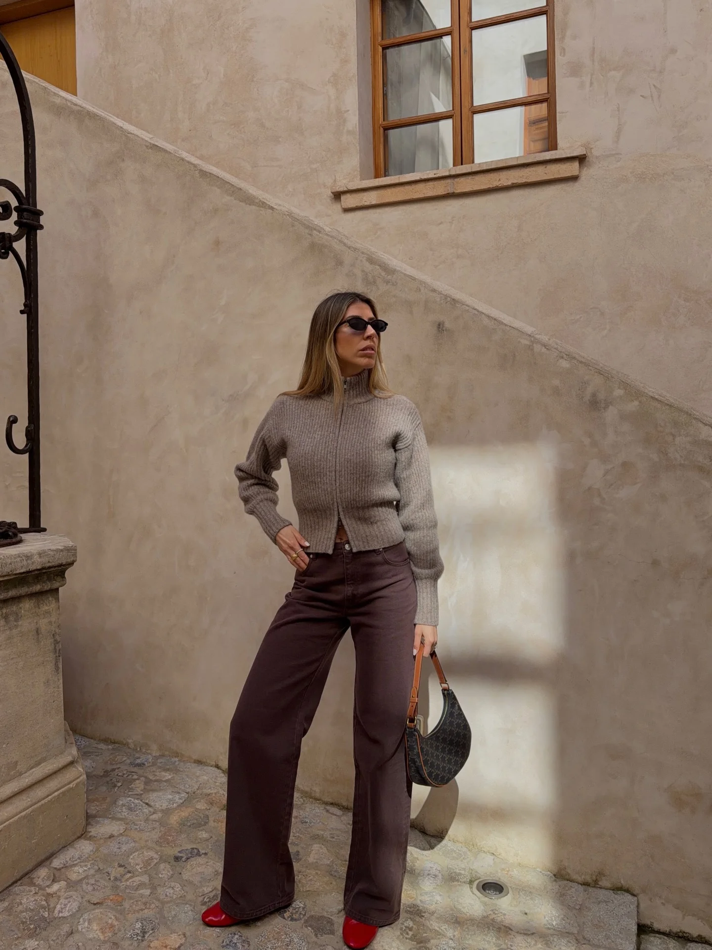best fall outfits for women 2026 Soft Taupe Knit With Chocolate Denim And Bold Red Shoes