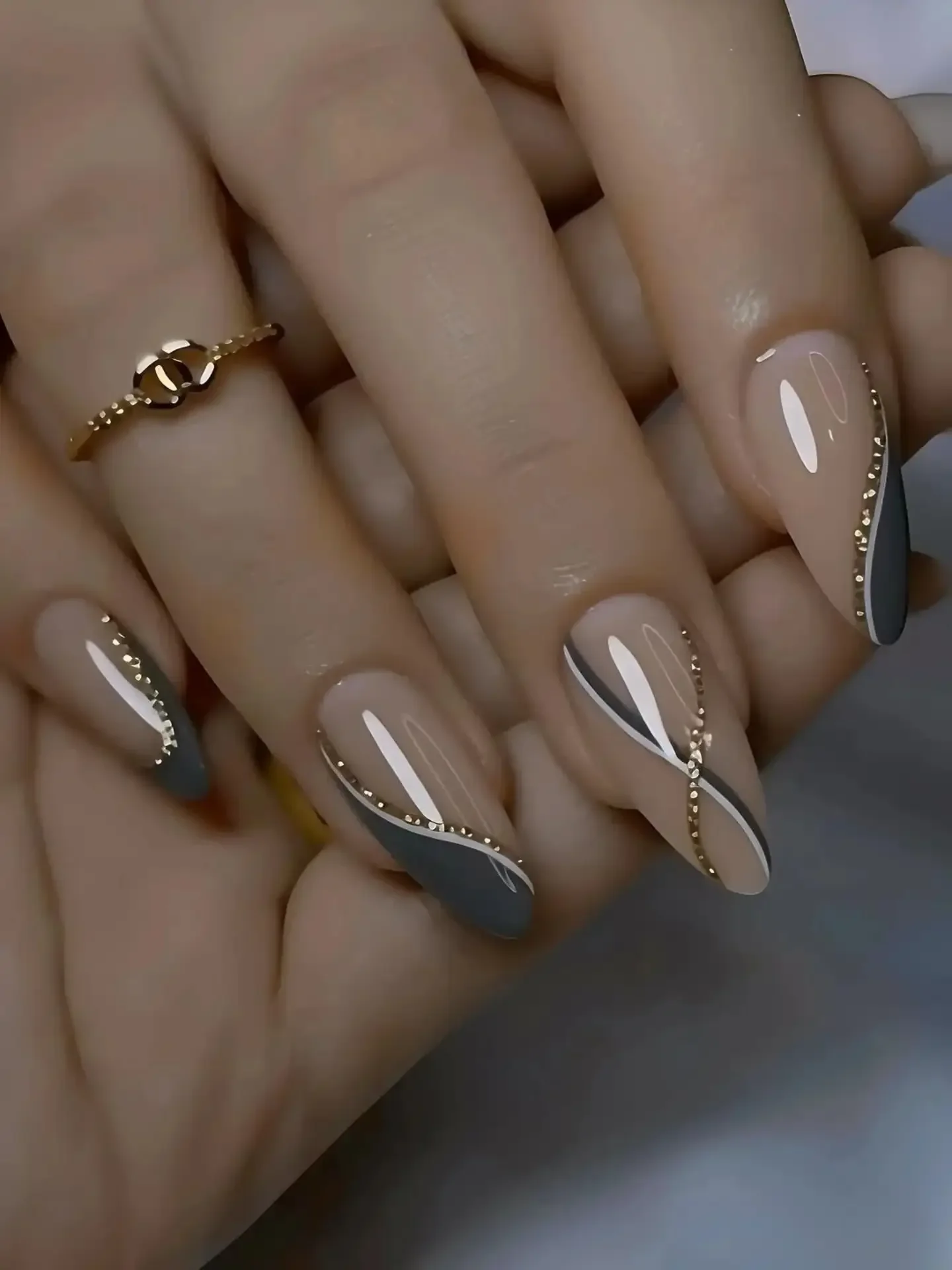 fall acrylic nails 2026 Elegant Taupe Almond Nails With Gold Wave Details