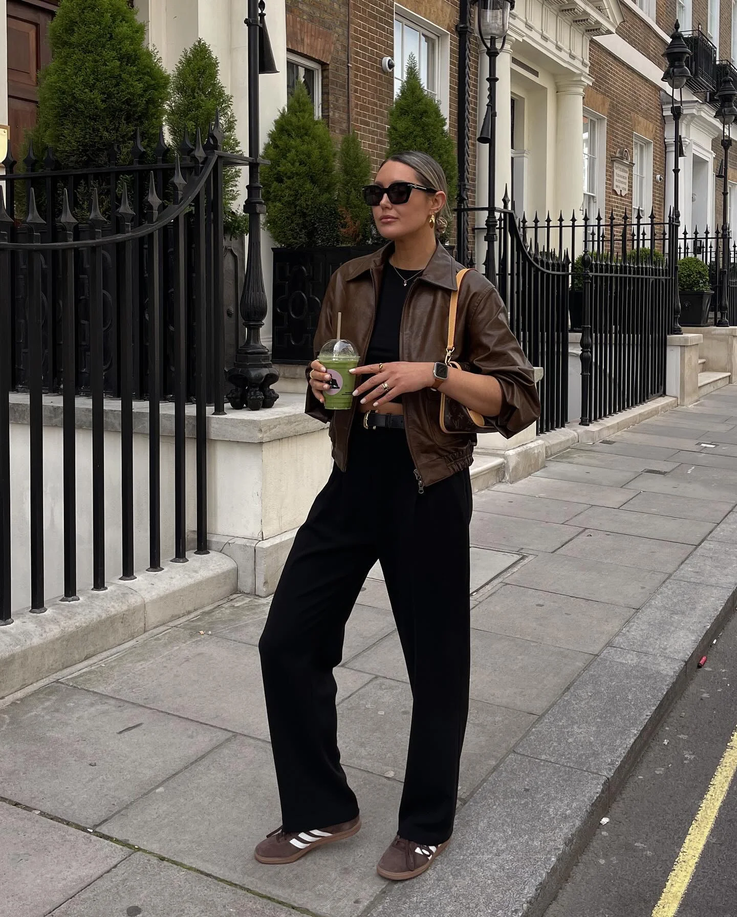 best fall outfits for women 2026 Brown Leather Jacket And Relaxed Black Trousers For Everyday Ease