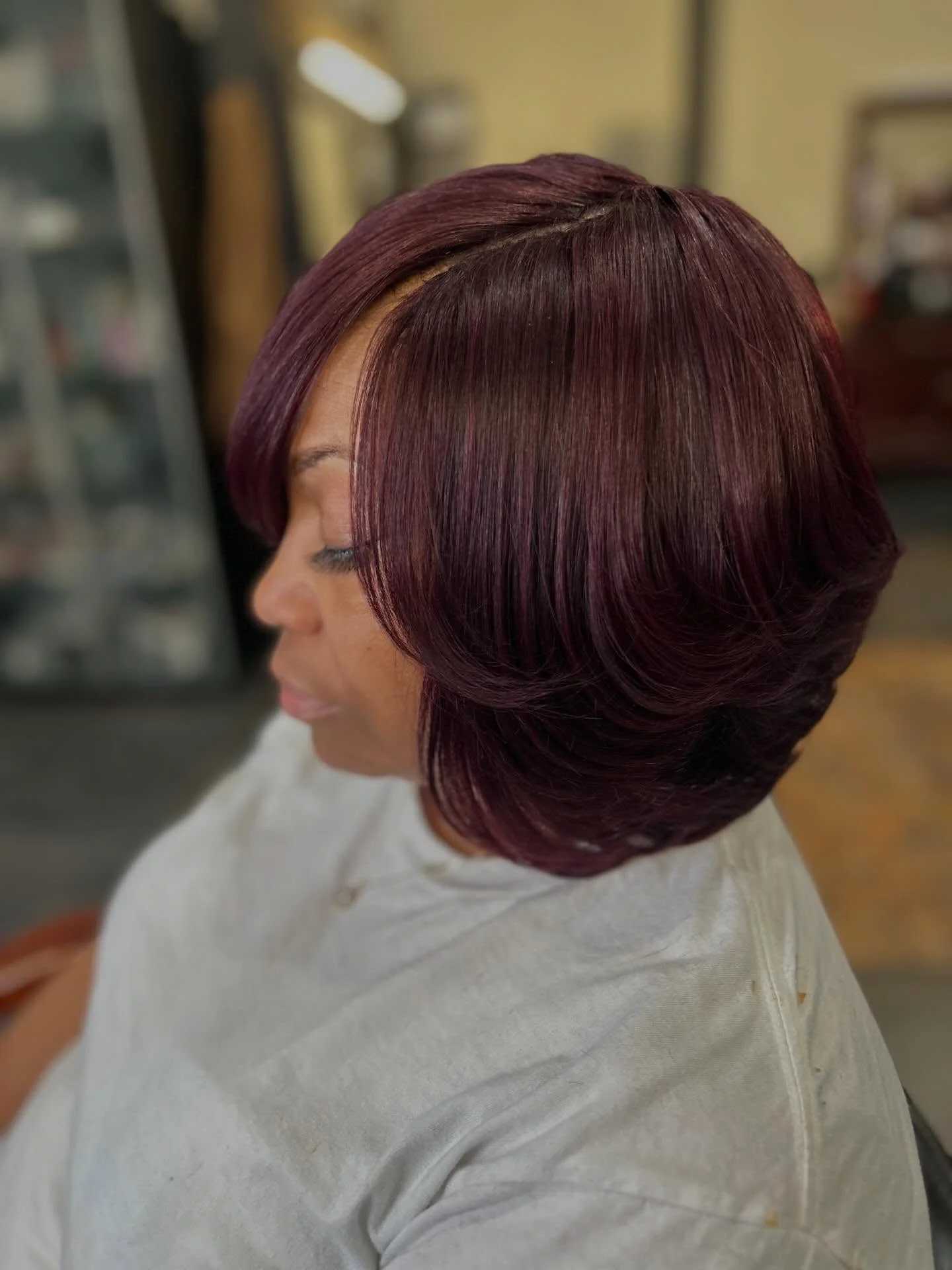 bob hairstyles for black women Deep Burgundy Layered Bob With Side Swept Fringe