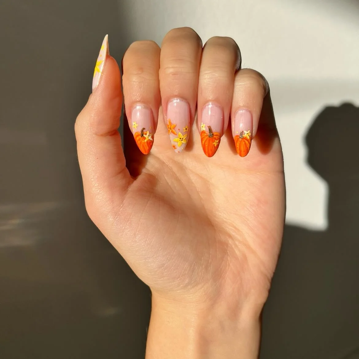 fall nail for all plates skin 2026 Whimsical Pumpkin French Tips With Tiny Autumn Blooms