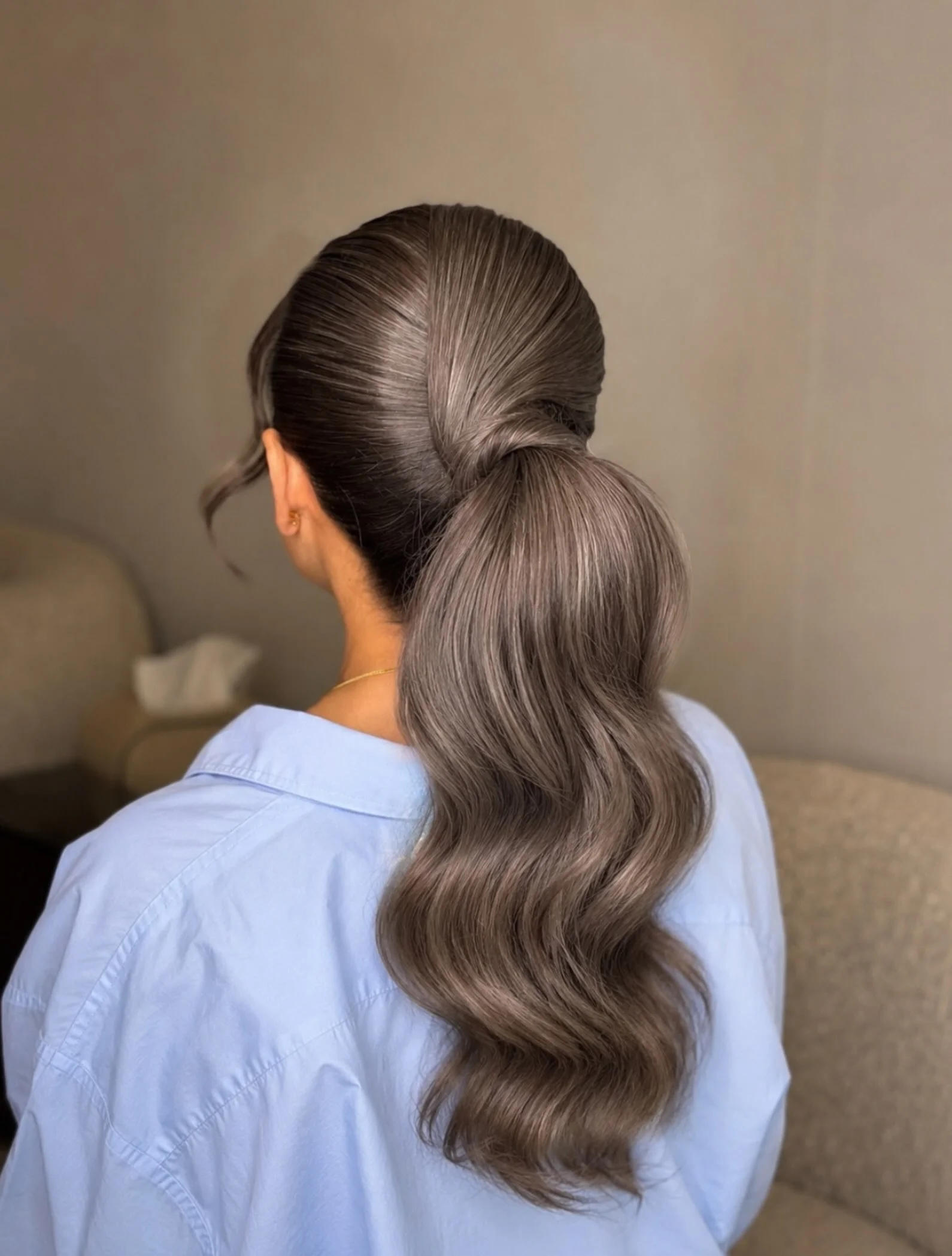 body waves hairstyle Glossy Low Ponytail With Sculpted Waves