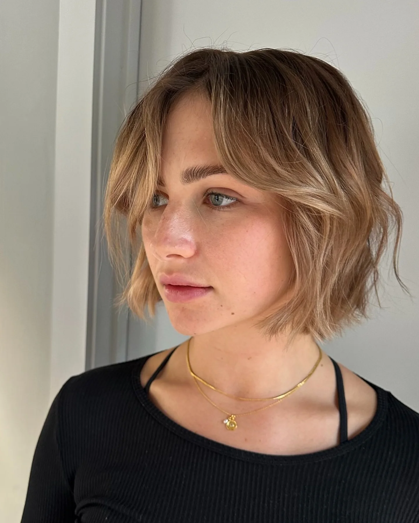 dirty blonde hair color French Bob With Curtain Bangs And Warm Blonde Softness