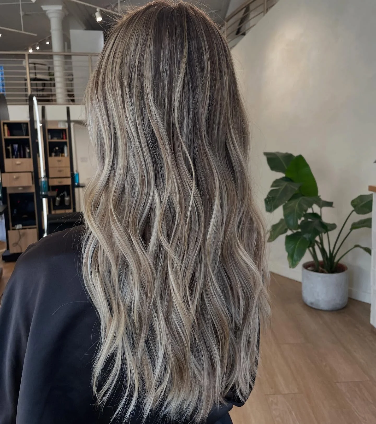 dirty blonde hair color Cool-Toned Dirty Blonde Waves With Luminous Balayage Finish