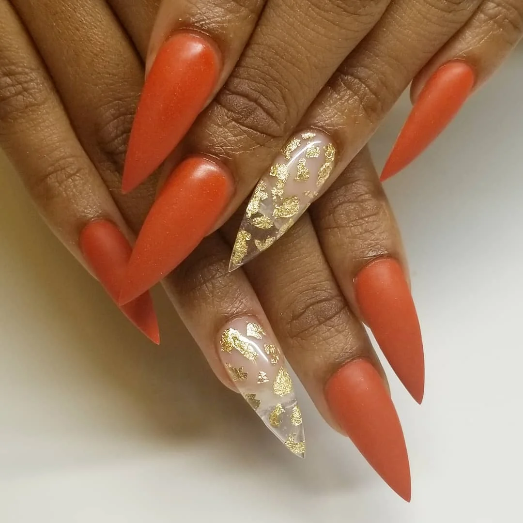 fall acrylic nails 2026 Burnt Orange Stiletto Nails With Gold Foil Accents