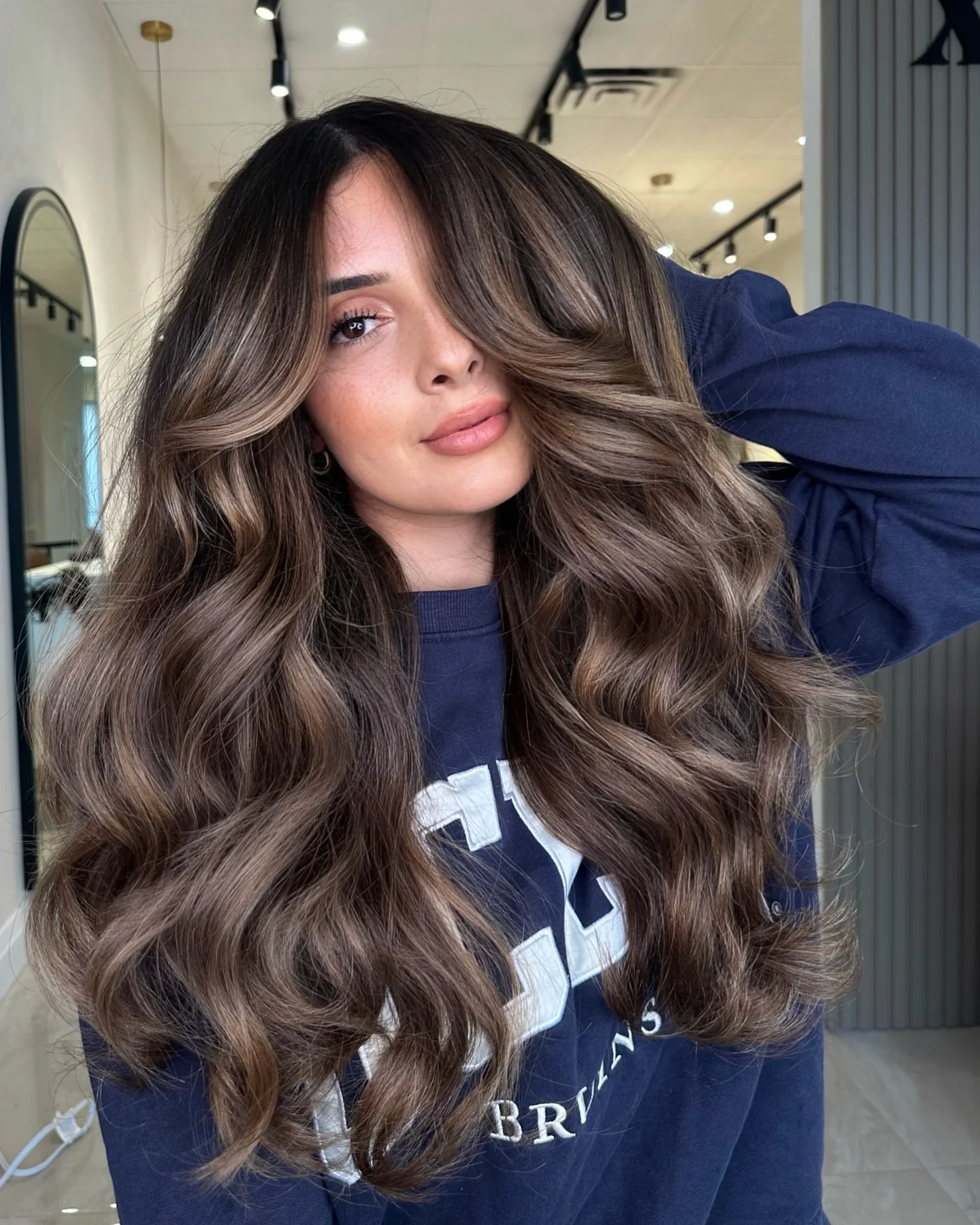 dimensional brunette hair color Cool Mocha Layers With Statement Curtain Bangs