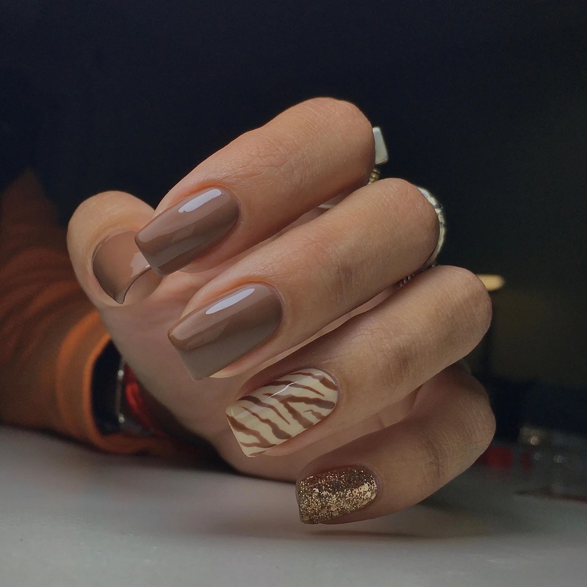 september nail designs 2026 Glossy Taupe With Modern Zebra Accent