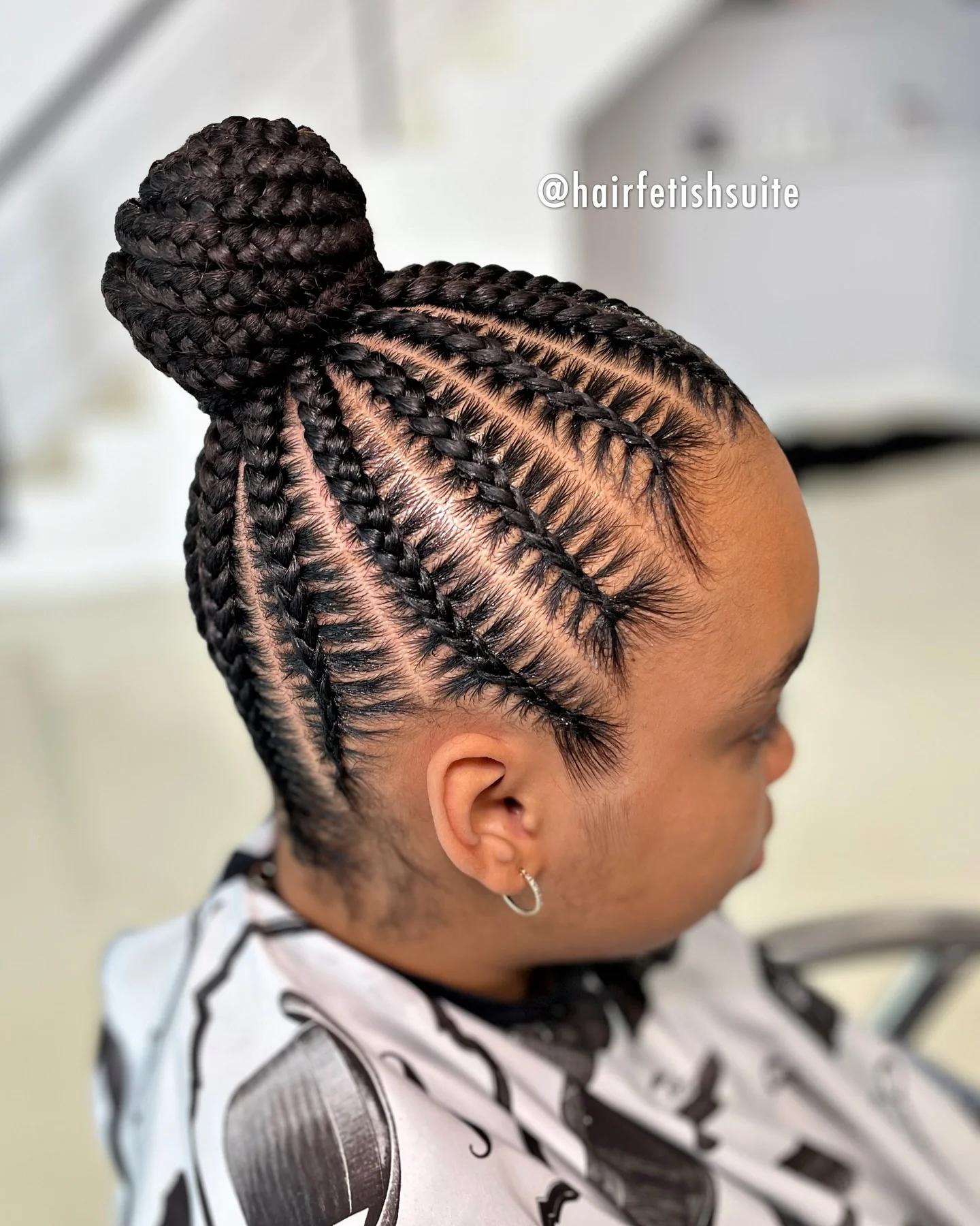 feed in braid hairstyles Sleek Feed-In Braid Bun With Defined Cornrow Patterns