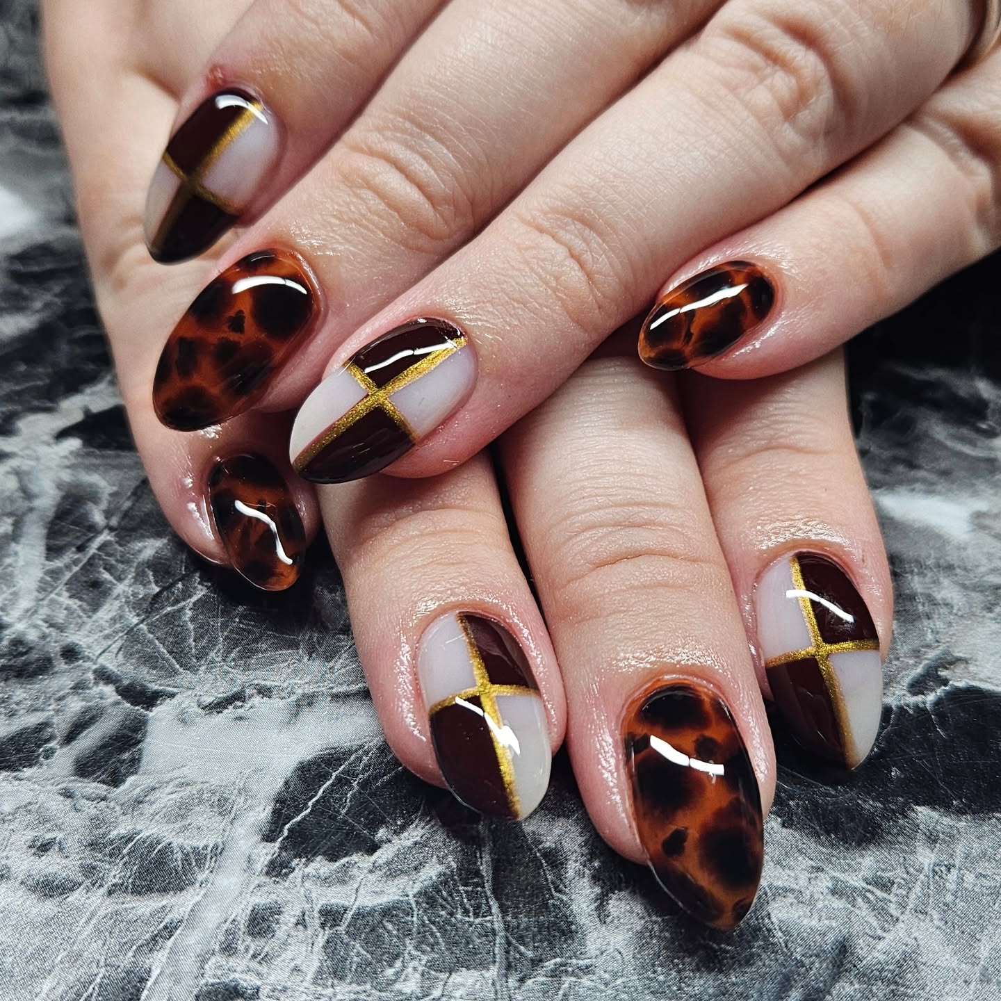 fall medium nail ideas 2026 Modern Tortoiseshell With Graphic Gold Lines