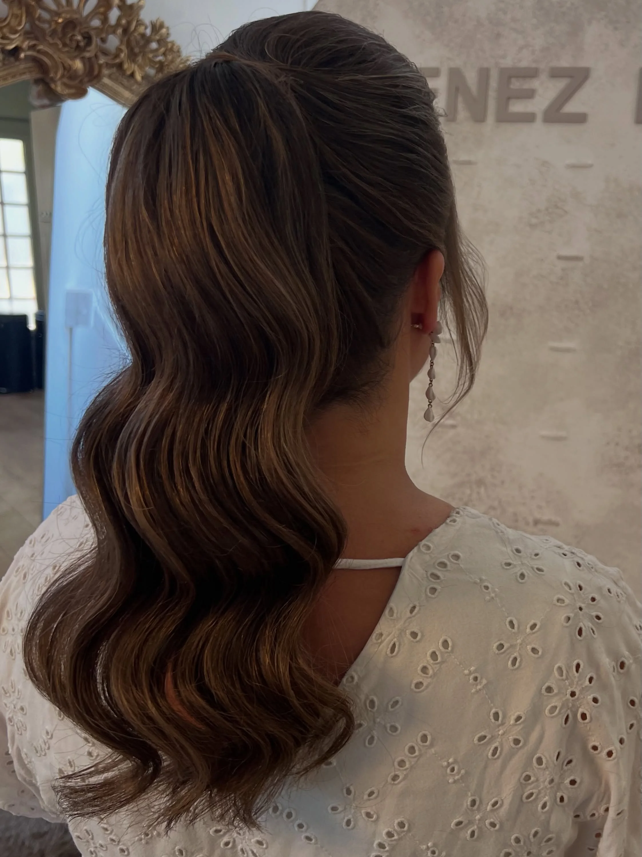 body waves hairstyle Polished Low Ponytail With Sculpted Body Waves