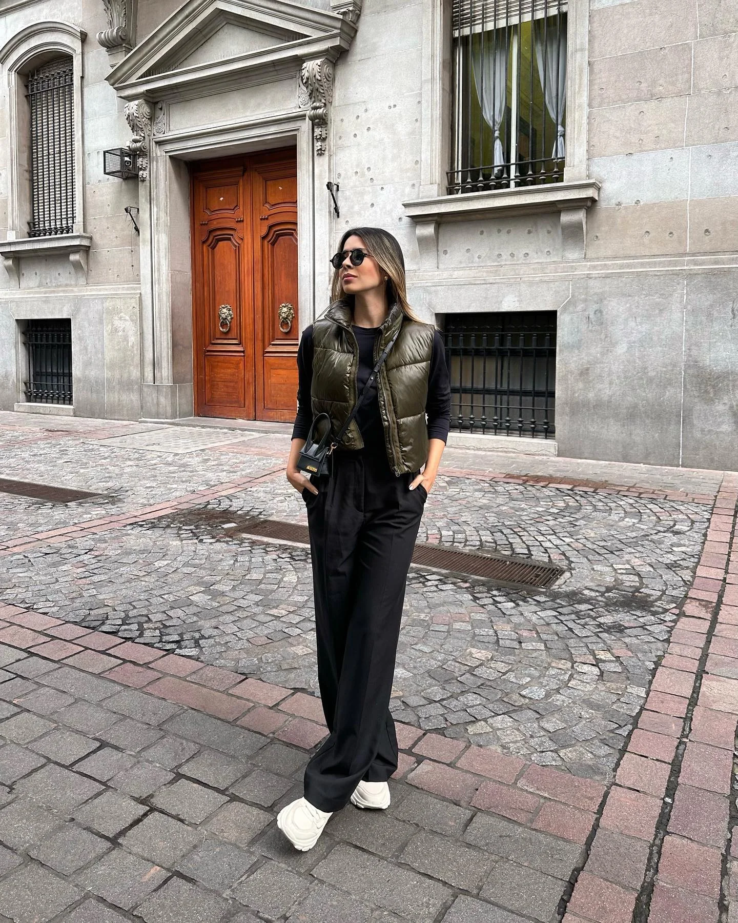 fall comfy outfits 2026 Minimal Black Outfit Finished With An Olive Puffer Vest