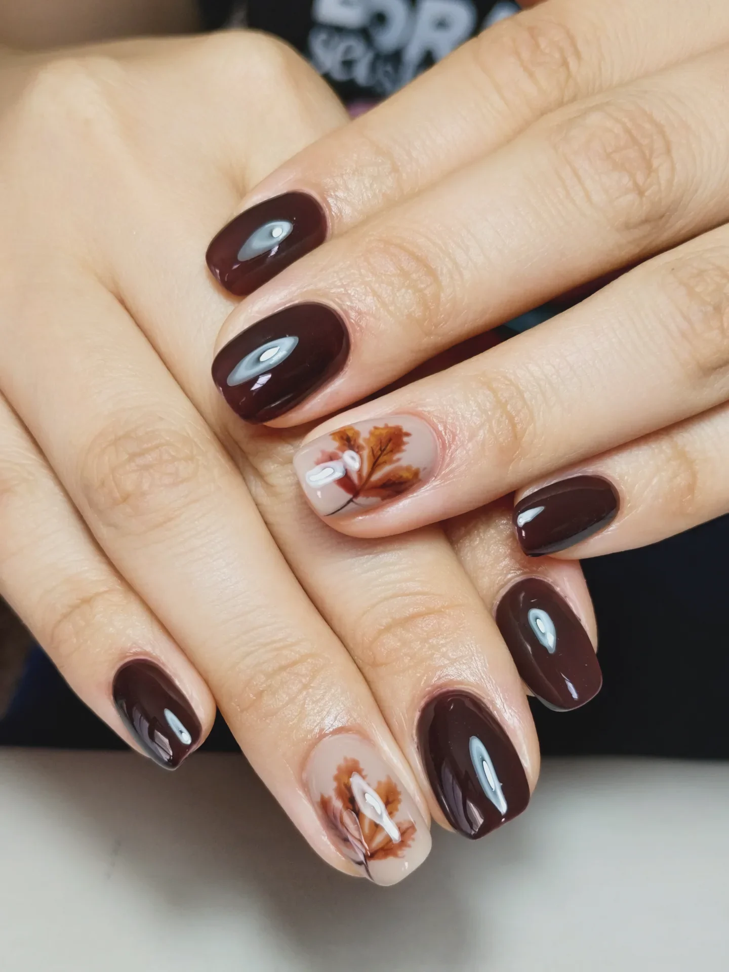 september nail designs 2026 Chocolate Gloss With Delicate Autumn Leaf Art