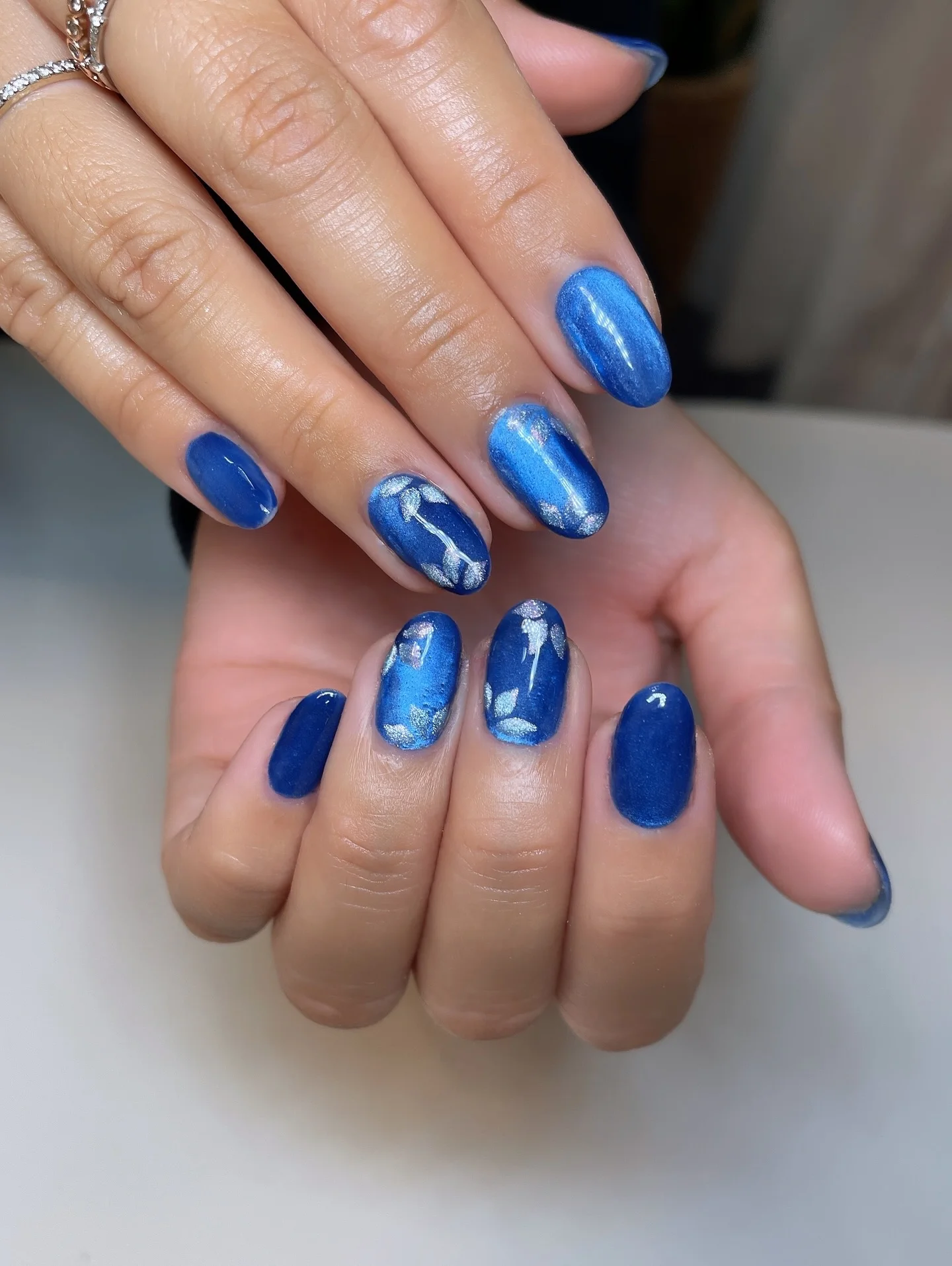 nail designs for august 2026 Shimmering Sapphire Blue With Artistic Metallic Accents