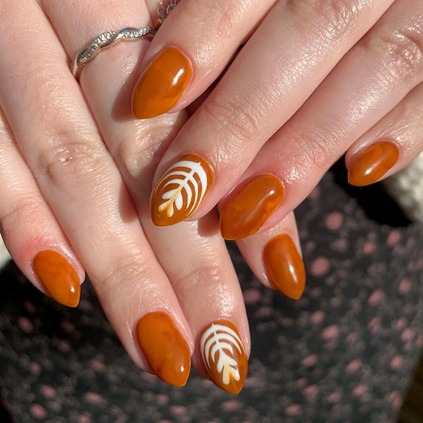 fall nails with accent nail Glossy Amber Nails With A Delicate Leaf Accent