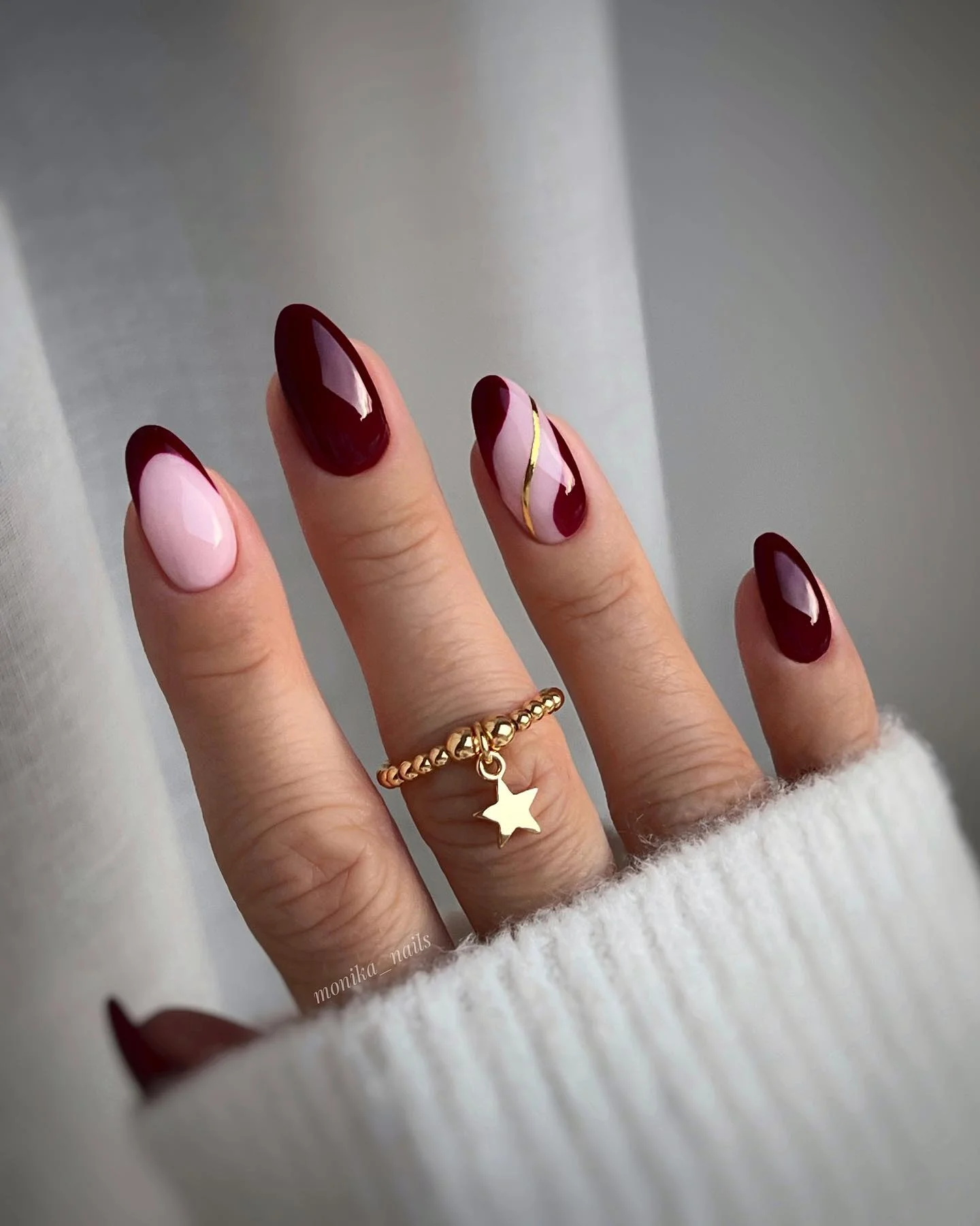 maroon fall nails 2026 Glossy Burgundy Almond Nails With Soft Pink And Gold