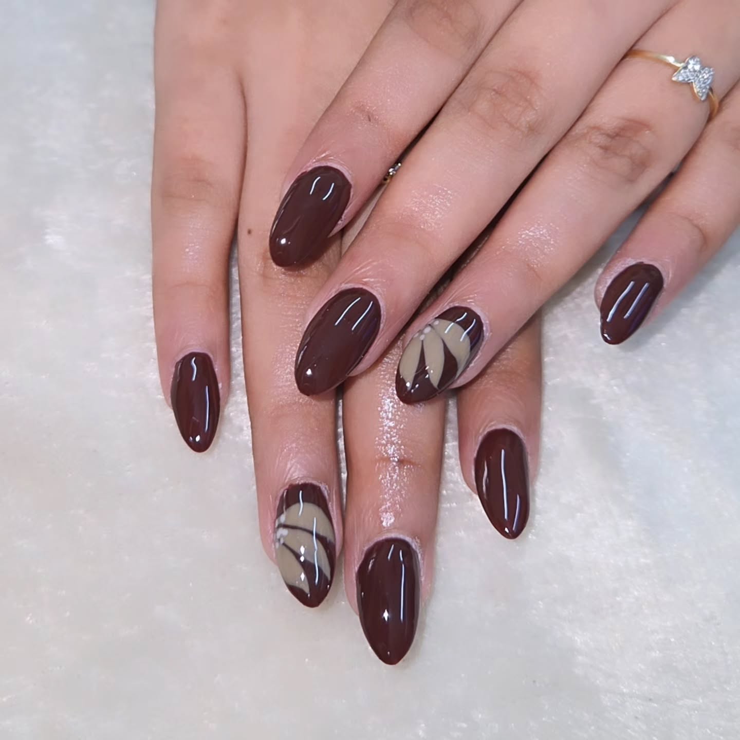 brown fall nails 2026 Chocolate Almond Nails With Modern Taupe Leaf Art