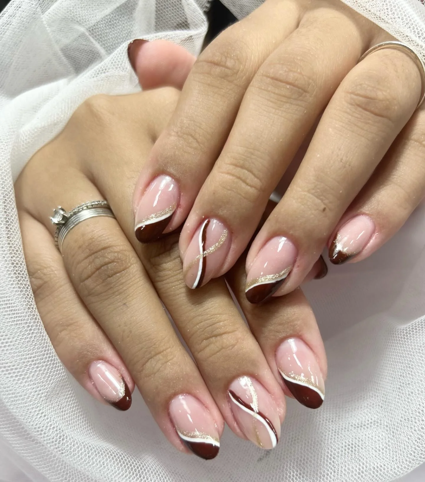 fall gel nails ideas 2026 Elegant Chocolate French Tips With Flowing Gold Waves
