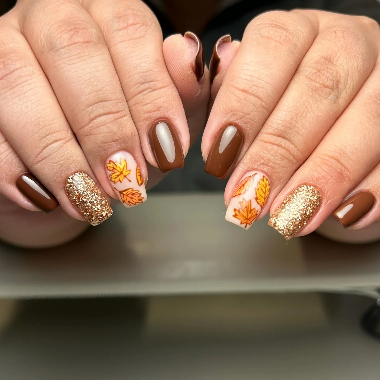 fall nail art ideas 2026 Chocolate Brown Nails With Golden Autumn Leaves
