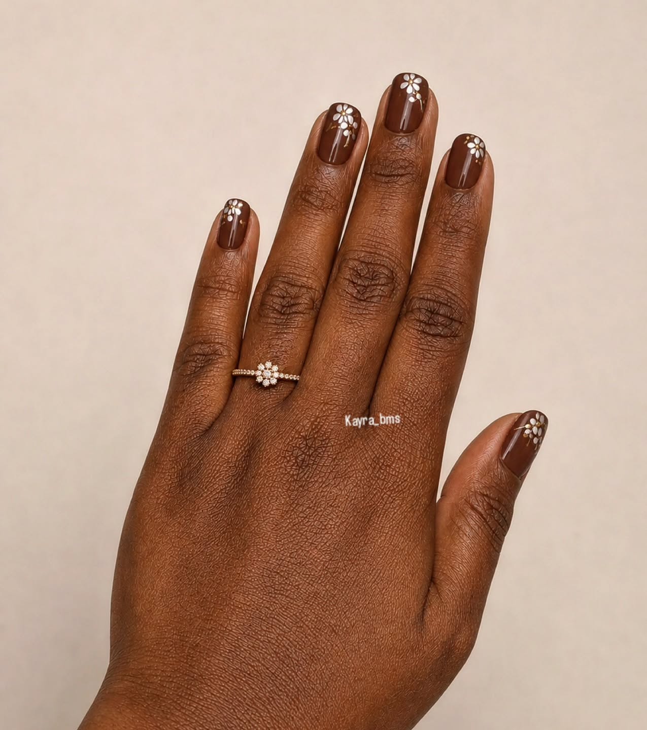 fall nails for dark skin 2026 Chocolate Daisy Nails With A Soft Vintage Touch