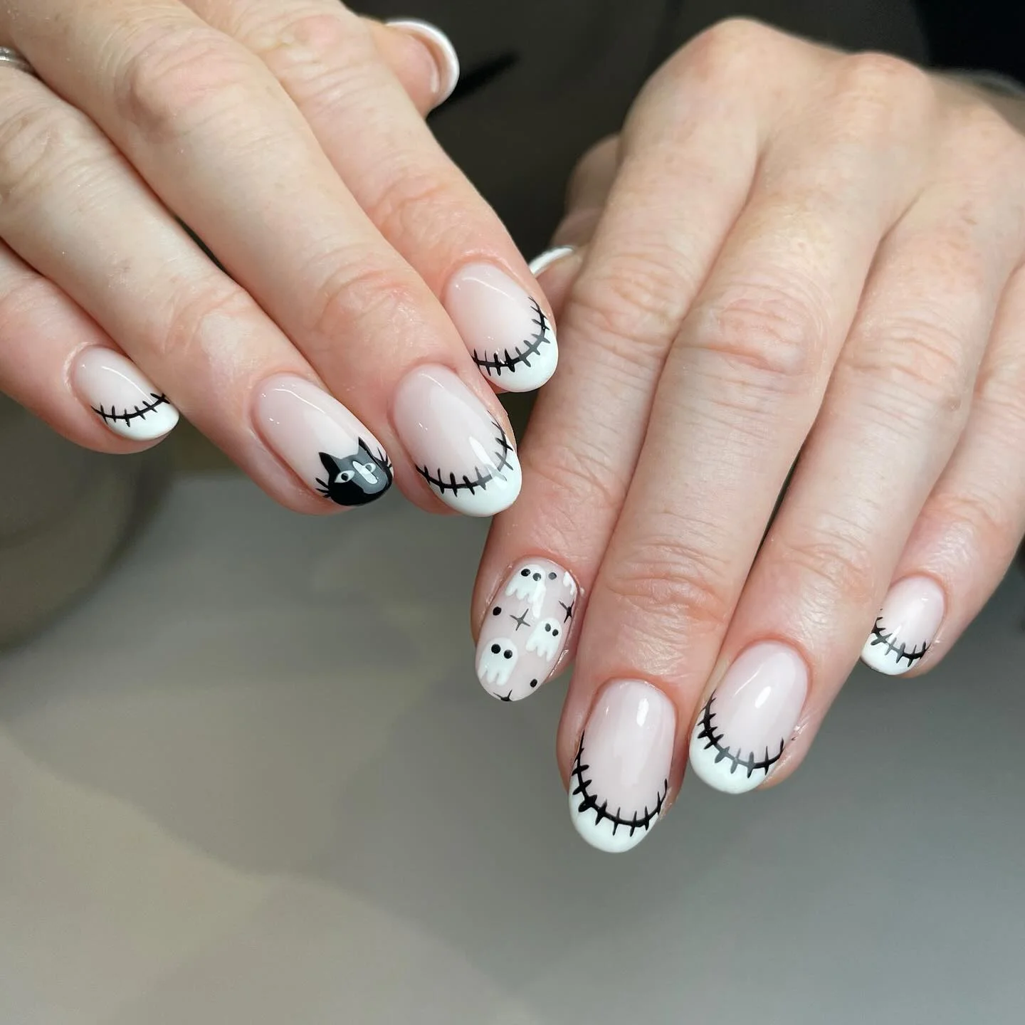 halloween nails designs 2026 Stitched White Tips With Playful Halloween Ghosts