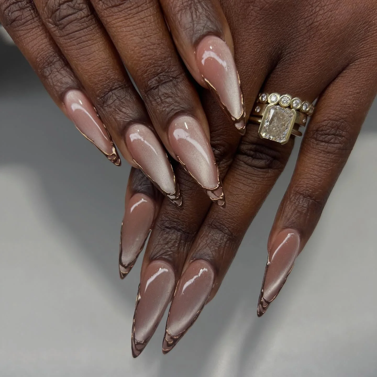fall nails for dark skin 2026 Pearlescent Nude Chrome With Elegant Gold Edges