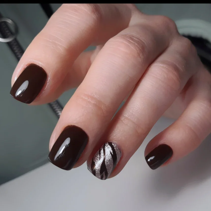 fall nails for fair skin tones 2026 Deep Espresso Brown With A Metallic Leaf Accent