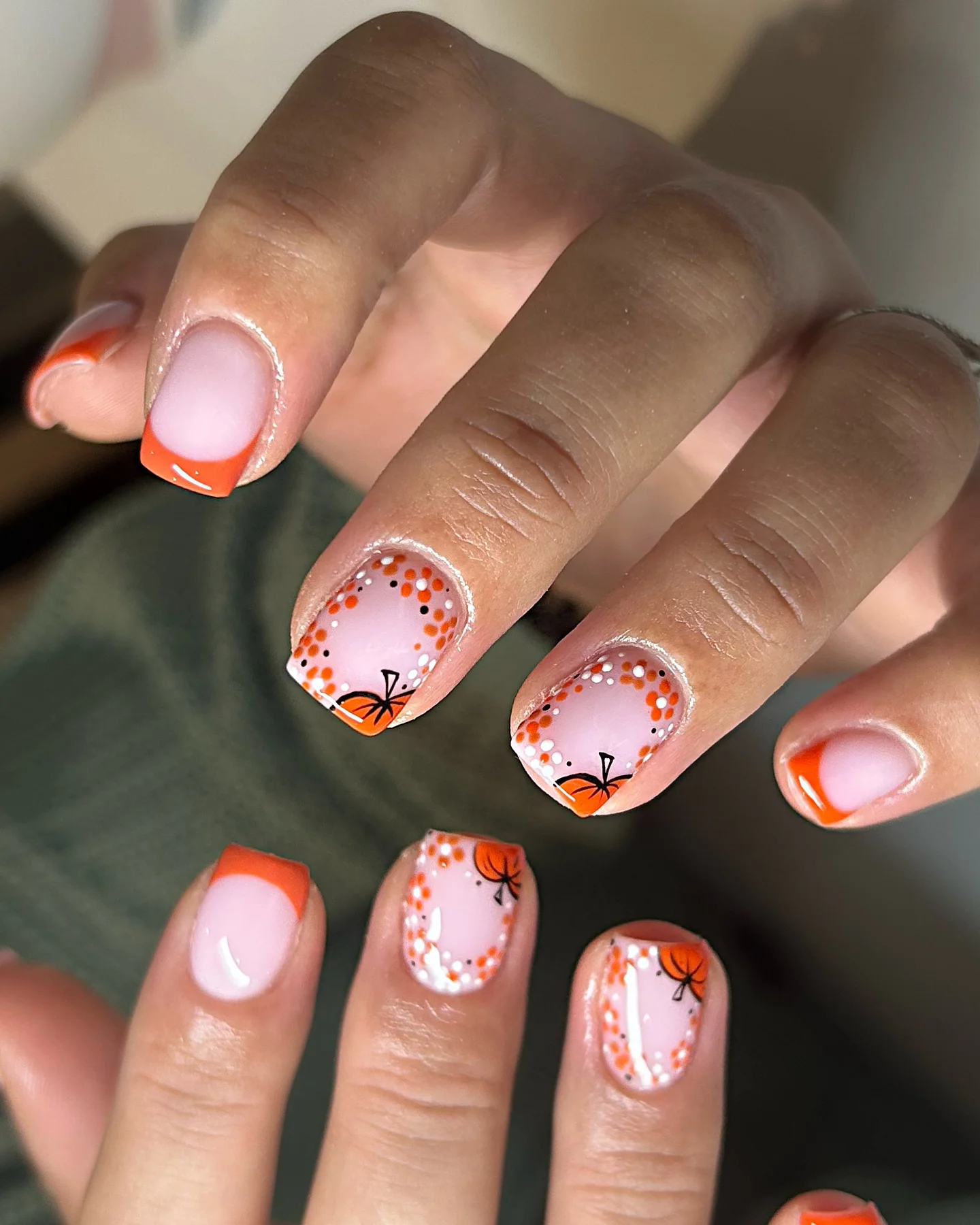 fall trendy nails 2026 Orange French Tips With Tiny Pumpkin Details