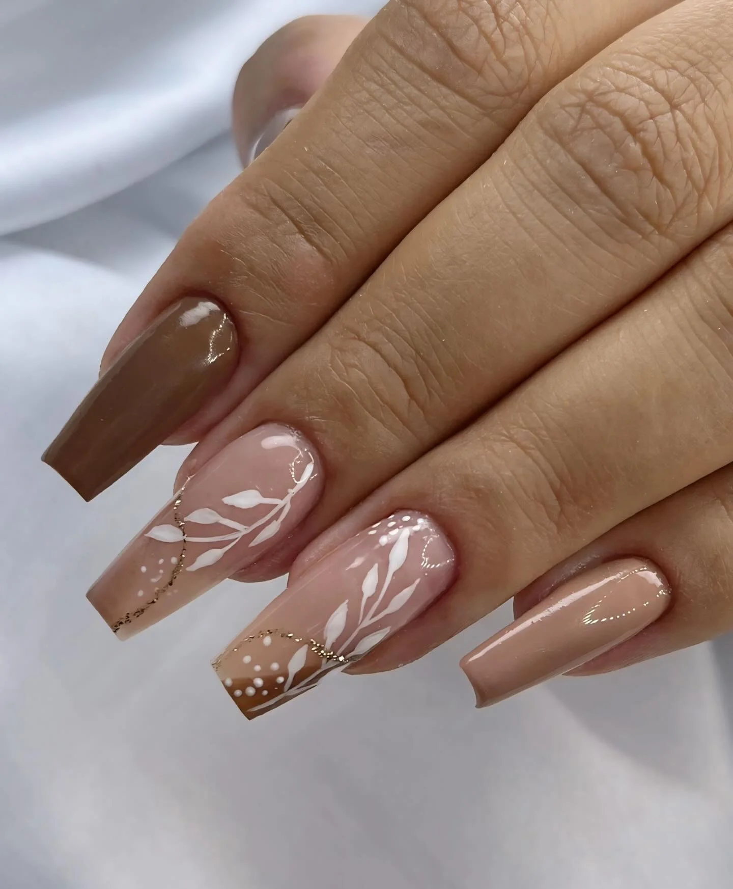 fall gel nails ideas 2026 Neutral Botanical Coffin Nails With Soft White Leaves
