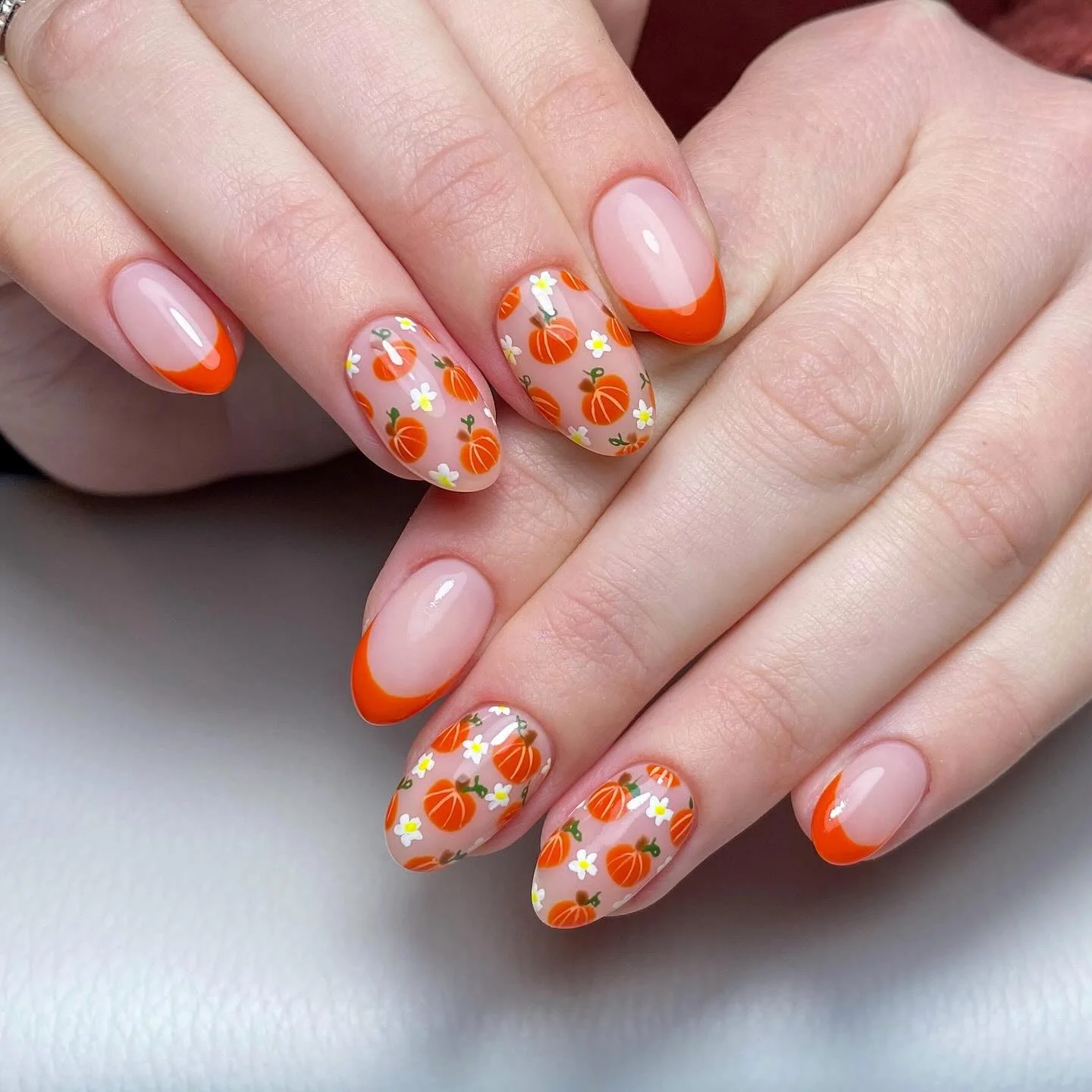 fall nail art ideas 2026 Pumpkin French Tips With Tiny Autumn Florals