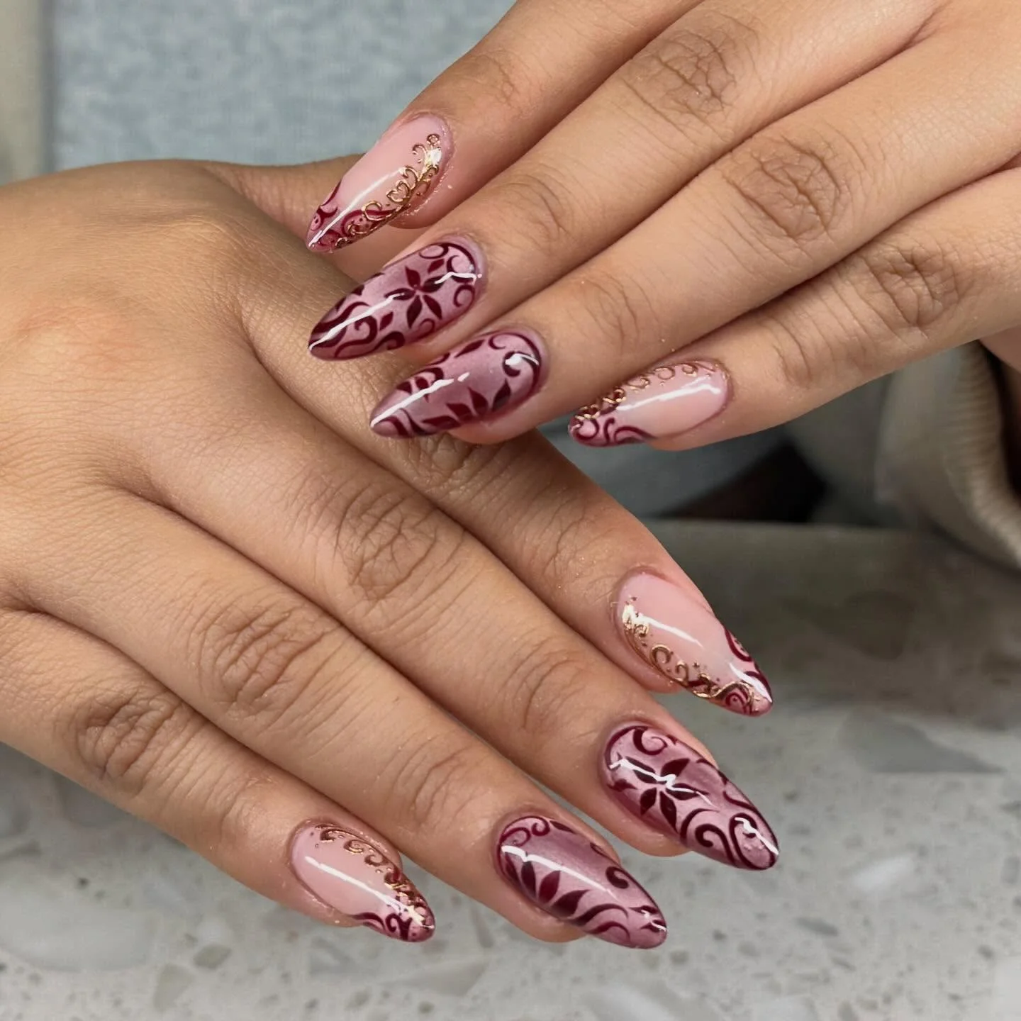 fall gel nails ideas 2026 Burgundy Floral Scrollwork With Delicate Gold Details