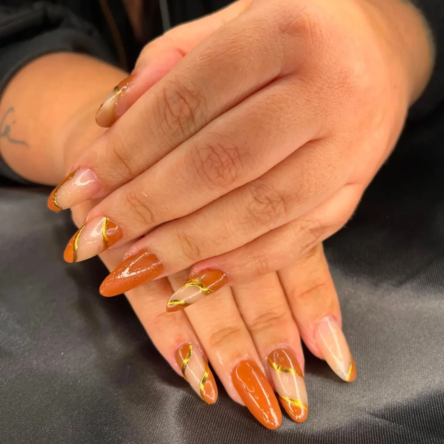 fall nails for tan skin tone Burnt Orange Almond Nails With Curved Gold Accents