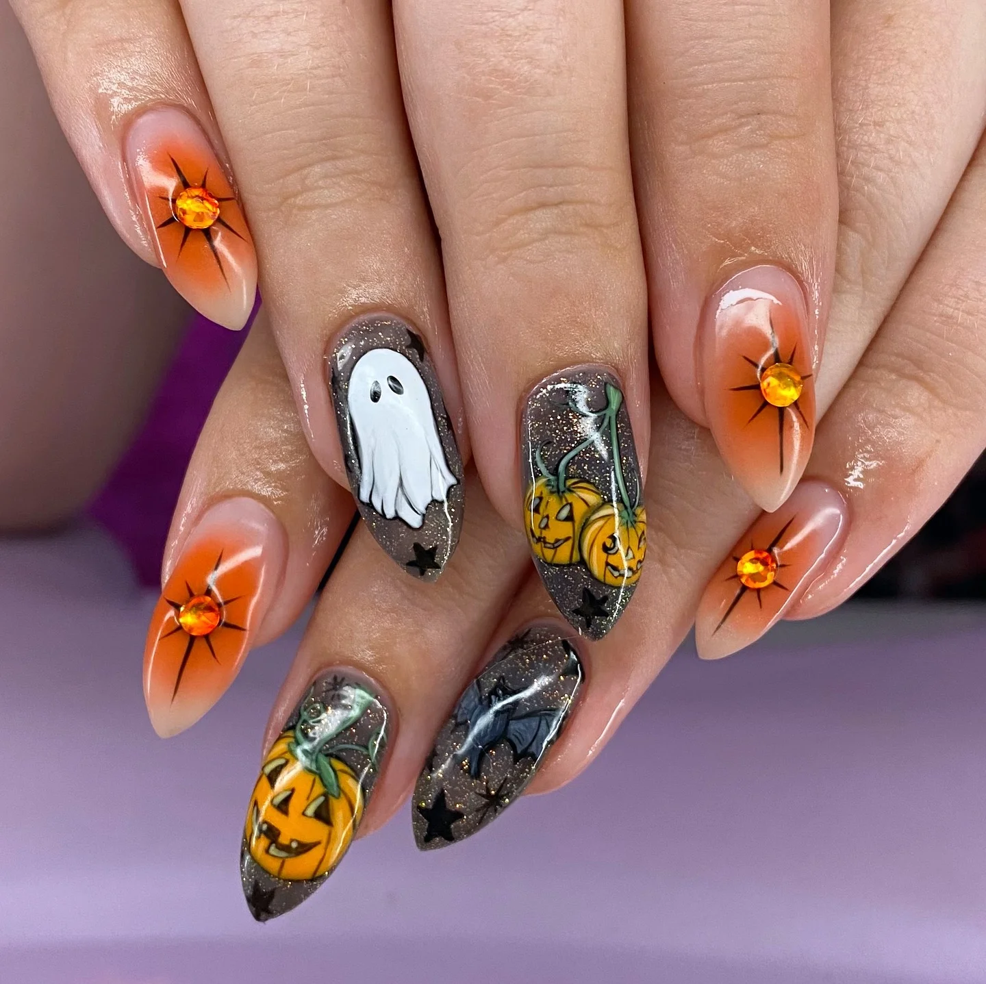 halloween nail art 2026 Glowing Pumpkin Nails With Amber Crystal Details