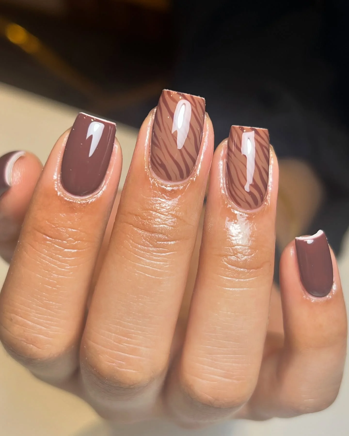 fall gel nails ideas 2026 Glossy Mocha Nails With Subtle Zebra Accent