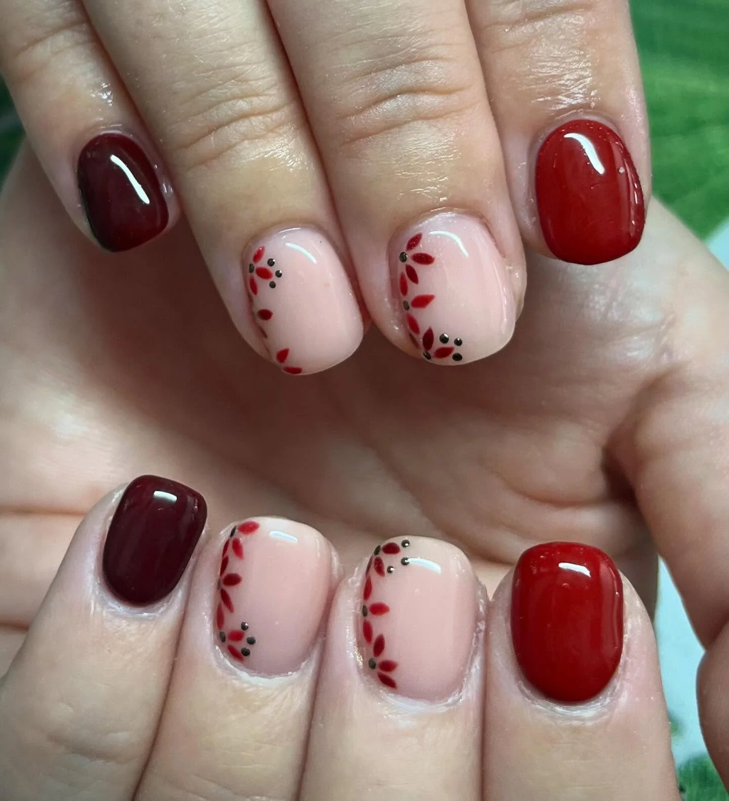 fall trendy nails 2026 Deep Burgundy Nails With Delicate Red Leaf Details